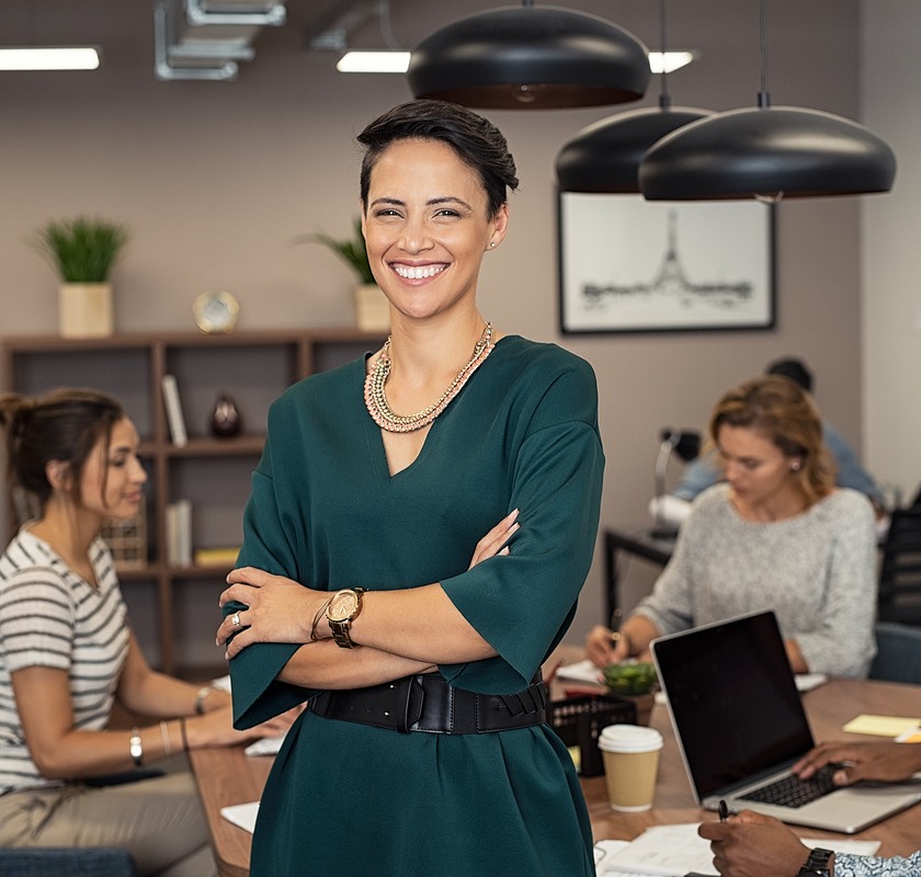 female arms crossed with a smile in office