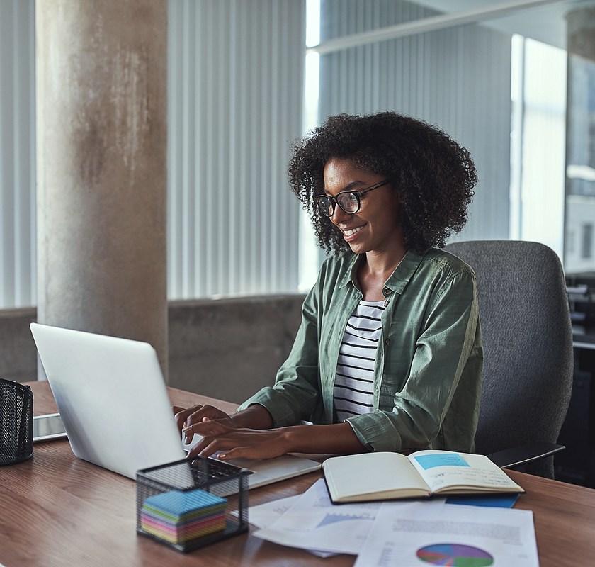 female smiling at laptop