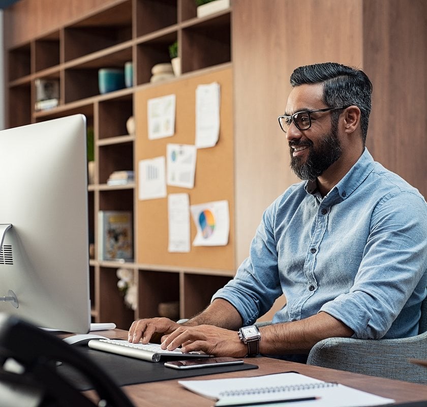 man sitting at computer