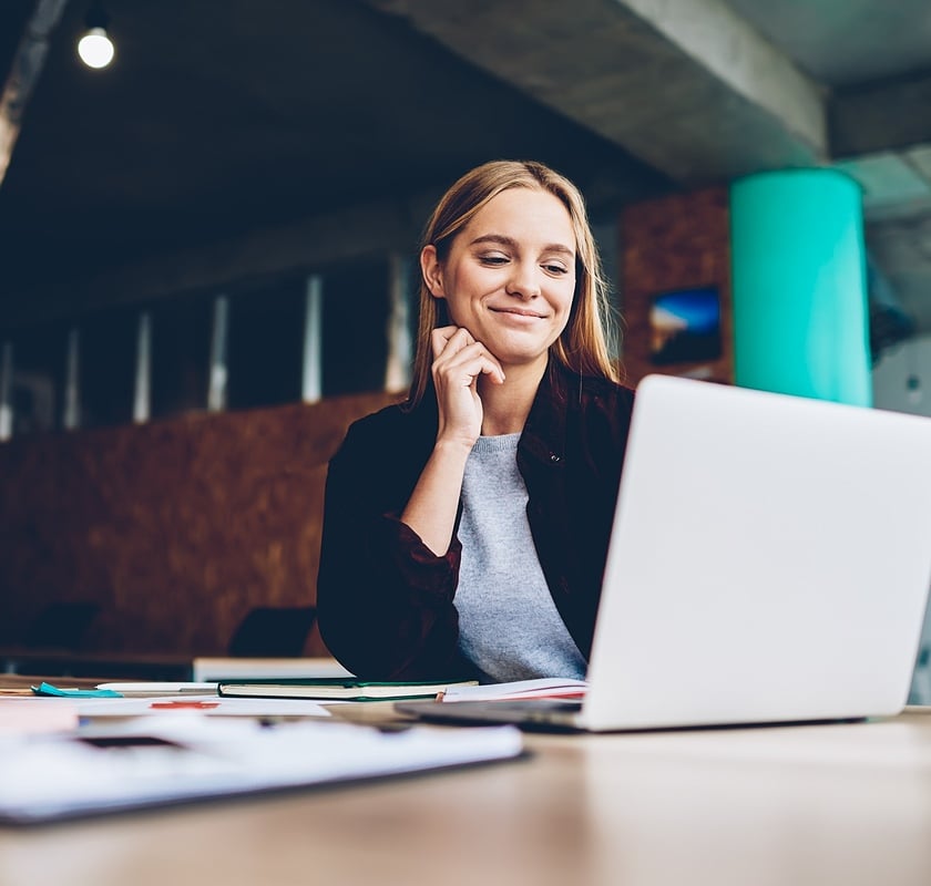 woman smiling at laptop